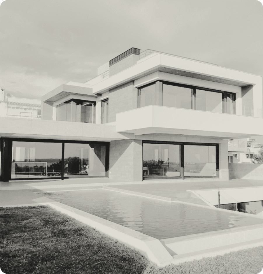 Black-and-white photograph of a modern home with a reflecting pool.