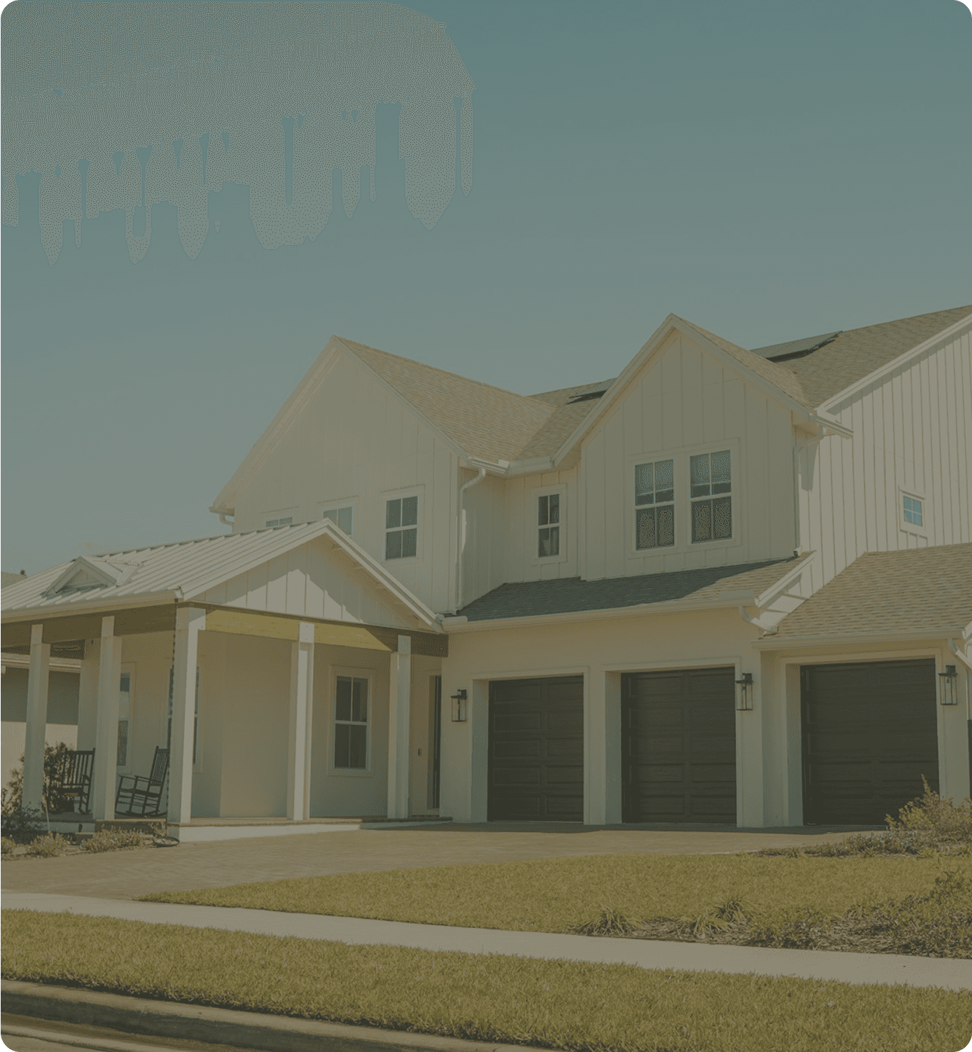 A two-story home with attached garages, photographed during a field assessment.