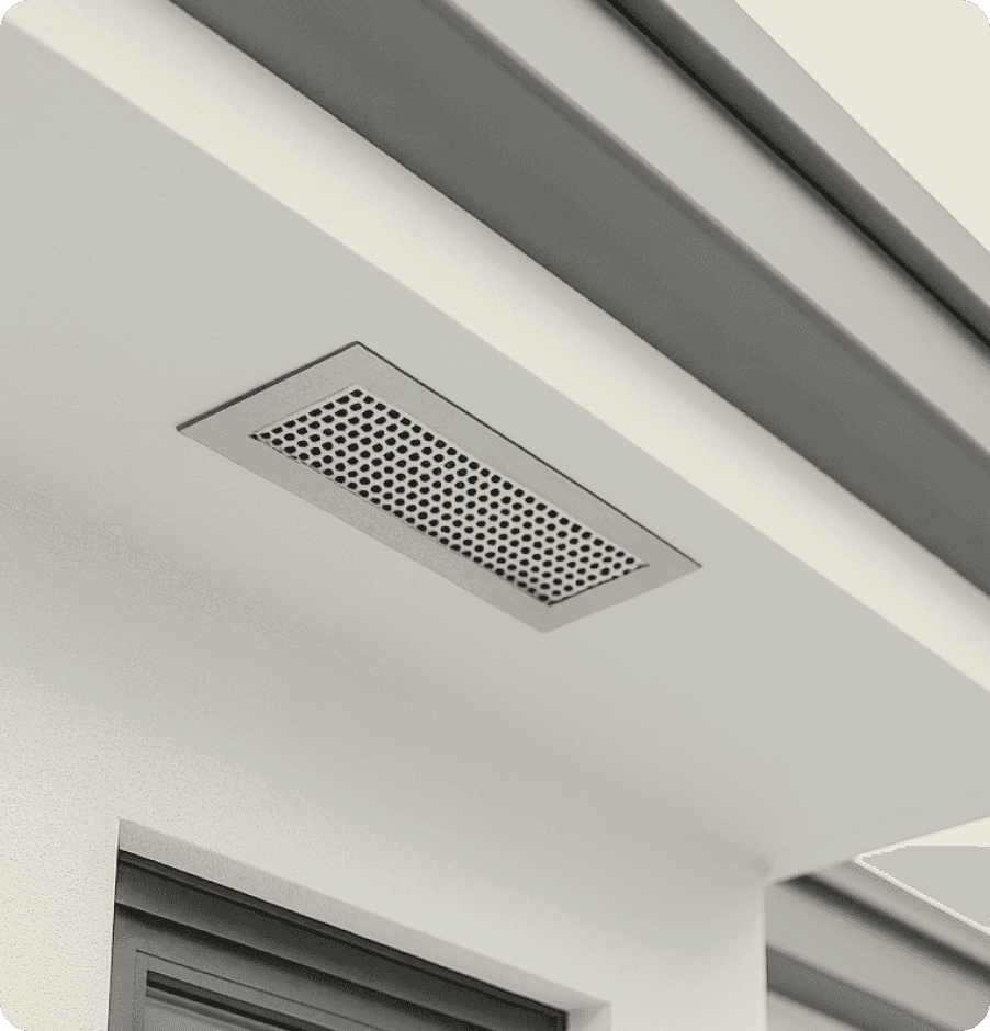Close-up of an ember-resistant attic vent on a modern home eave.