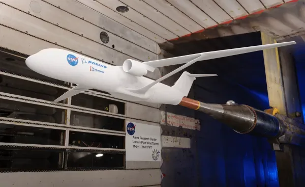 NASA wind tunnel scale model of an aircraft mounted in a test chamber.